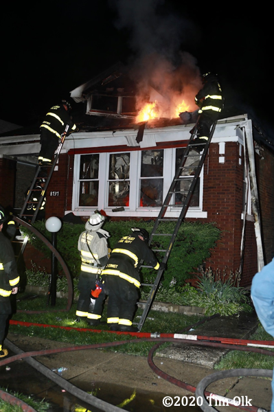 flames through roof of house on fire