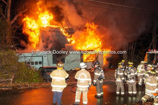 heavy flames from house fire at night