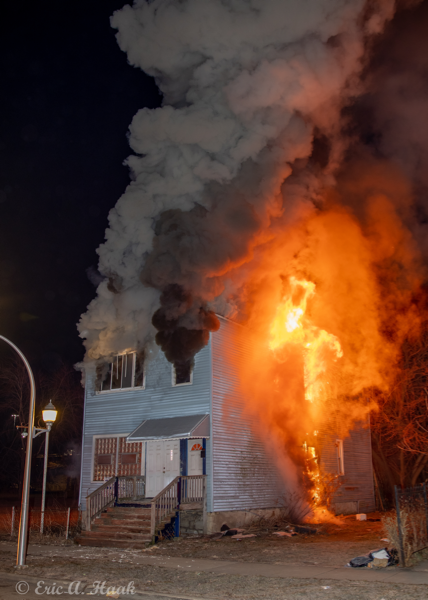 house completely engulfed by fire at night