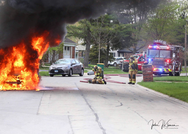 Firefighters in Buffalo Grove prepare to extinguish a minivan on fire