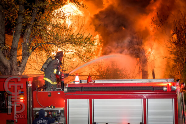 Detroit Firefighters battle fire in a house fully engulfed by flames